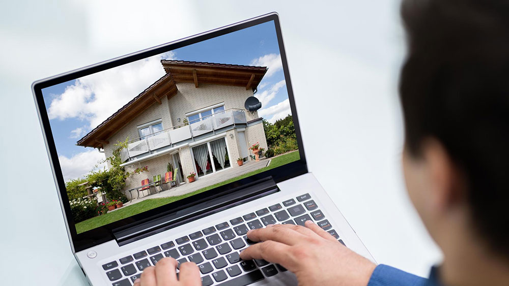 Homebuyer begins a virtual tour of a home on a laptop computer