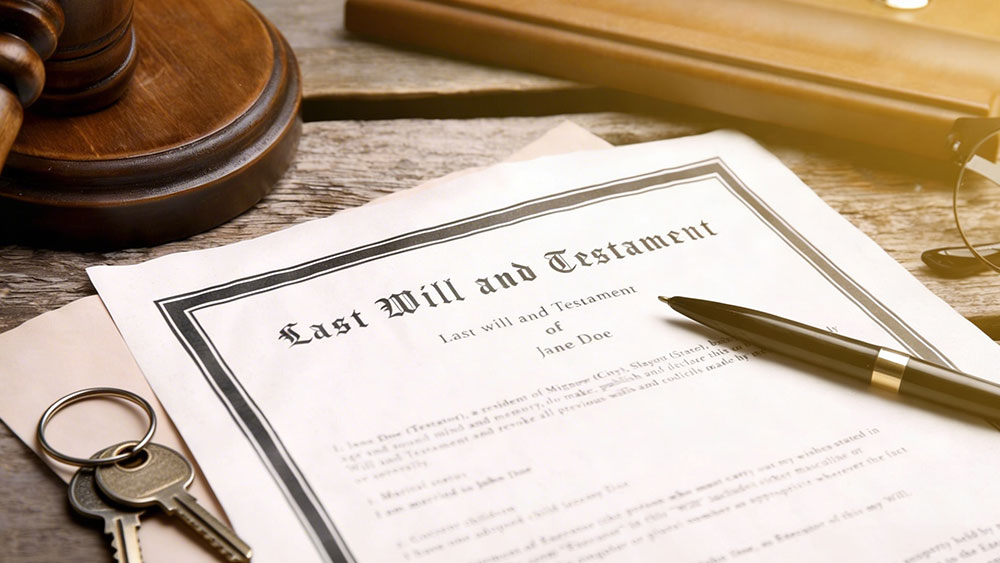Last will and testament, house keys, pen, and gavel on wooden table
